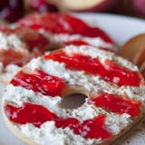 Hand rolled Bagel with Plain cream cheese and Jelly