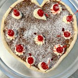 A heart-shaped pizza loaded with Nutella Cannoli Cream and Cherries!