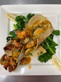 Pan seared sole topped with our clams and grilled shrimp over broccoli rabe