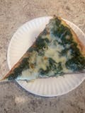 Spinach Alfredo pizza slice