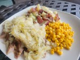 Pork in sauerkraut with redskins and corn