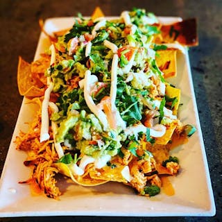 Chicken Tinga Nachos with Avocado & Crema