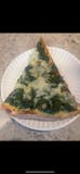 Spinach Alfredo pizza slice