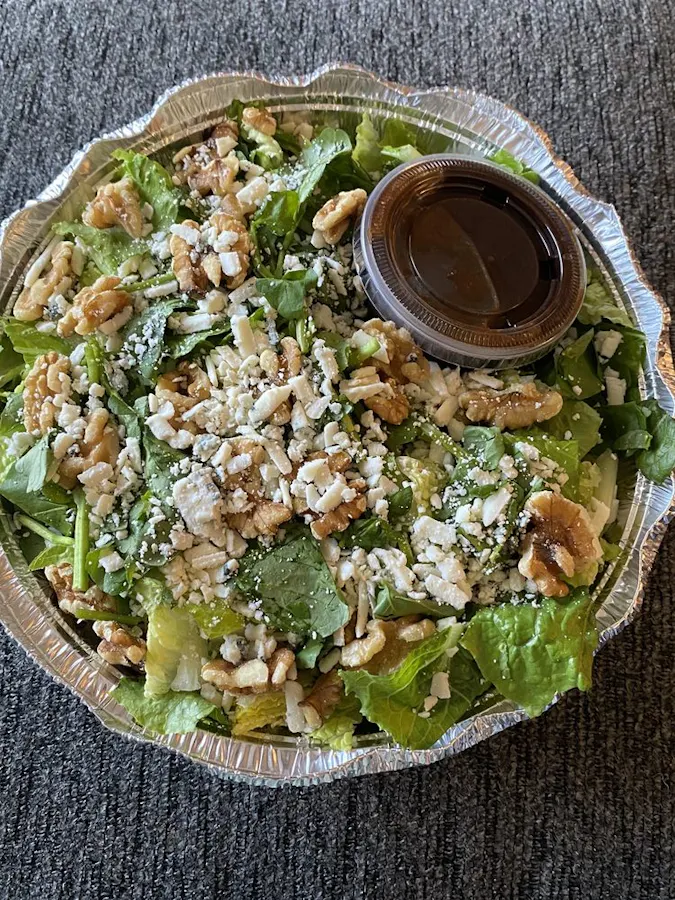 The The Salad — fresh romaine, watercress, gorgonzola, and walnuts in housemade balsamic dressing