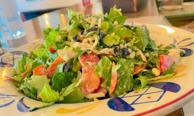 Chopped Salad — romaine, olives, basil, pepperoni, mozzarella, chicken and tomatoes with Italian vinaigrette