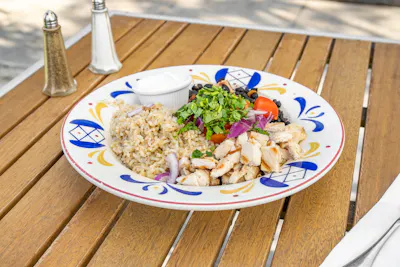 Baja Bowl — brown rice, seasoned black beans, chicken, fresh tomato, cilantro, avocado, and onion