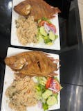 Fresh whole tilapia served with rice and salads
