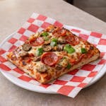 Sicilian Four Toppings Pizza Slice